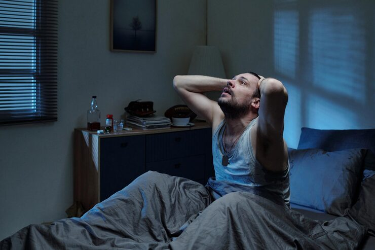 man-sitting-in-bed-feeling-stressed-at-night_274679-59253